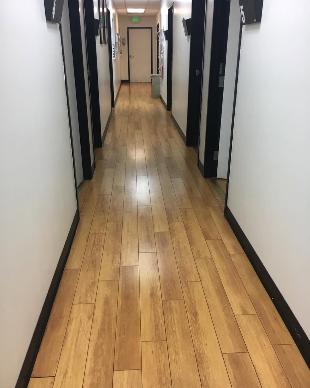 Wood-look clinic hallway after detailed cleaning